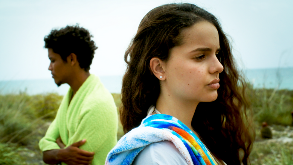 Esta Isla movie still showing two people standing on a shore